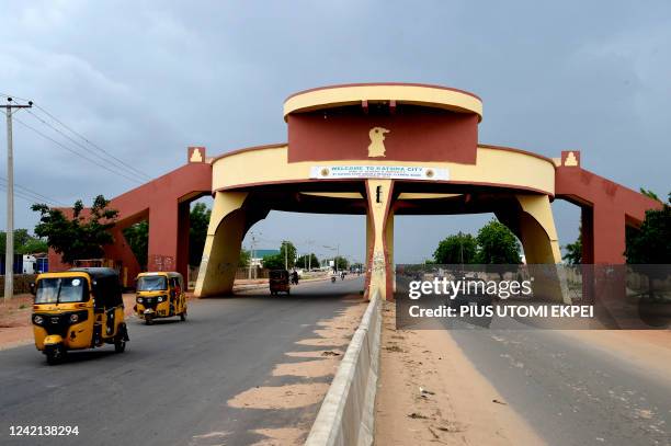 Taxi rick-shaws drive past Katsina State city gate in northwest Nigeria, on July 20, 2022. - Thousands of children are caught up in acute...