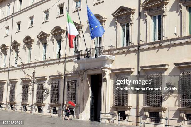 Woman with red umbrella enters Palazzo Chigi seat of the Government during the meeting between Prime Minister Mario Draghi, and the general...