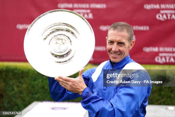 Jockey Jim Crowley celebrates with the trophy after winning the Qatar Sussex Stakes on day two of the Qatar Goodwood Festival 2022 at Goodwood...