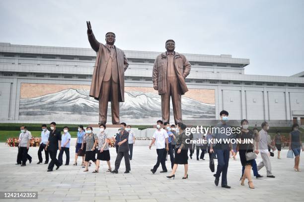 People visit the statues of the late North Korean leaders Kim Il Sung and Kim Jong Il on Mansu Hill in Pyongyang on July 27 on the occasion of the...