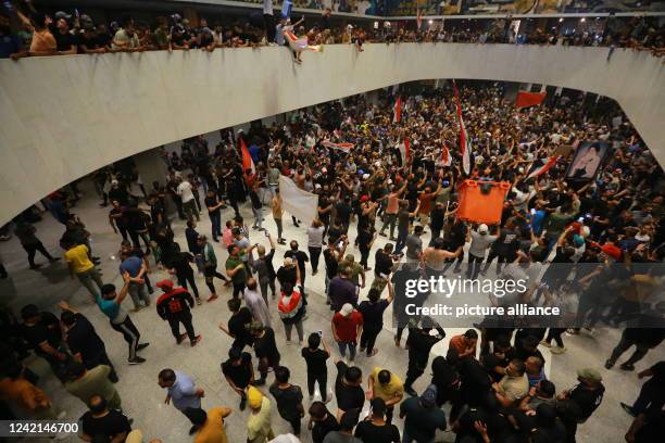 July 2022, Iraq, Baghdad: Supporters of Iraq's influential Shiite cleric Moqtada al-Sadr protest inside the Parliament building after breaching the...