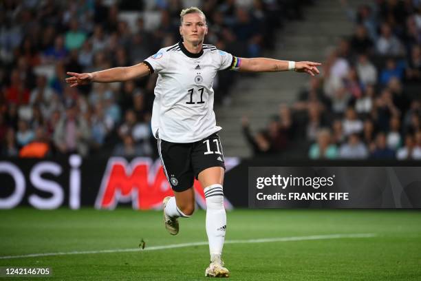 Germany's striker Alexandra Popp celebrates scoring the opening goal during the UEFA Women's Euro 2022 semi-final football match between Germany and...