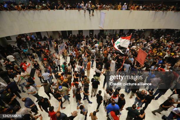 July 2022, Iraq, Baghdad: Supporters of Iraq's influential Shiite cleric Moqtada al-Sadr protest inside the Parliament building after breaching the...