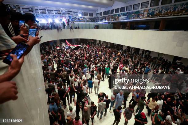 Supporters of the Iraqi cleric Moqtada Sadr gather inside the Iraqi parliament in the capital Baghdad's high-security Green Zone, as they protest at...