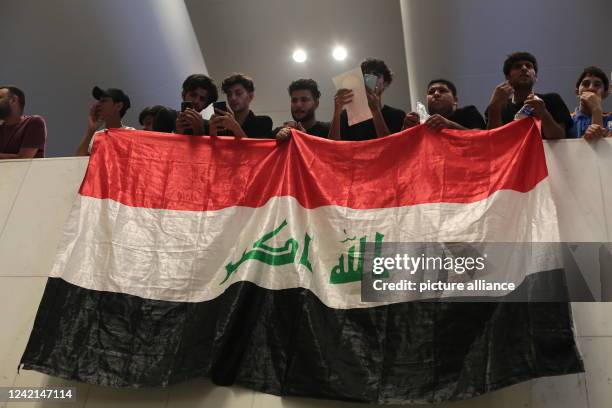 July 2022, Iraq, Baghdad: Supporters of Iraq's influential Shiite cleric Moqtada al-Sadr protest inside the Parliament building after breaching the...