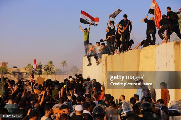 July 2022, Iraq, Baghdad: Supporters of Iraq's influential Shiite cleric Moqtada al-Sadr try to breach the Baghdad's fortified Green Zone, which...