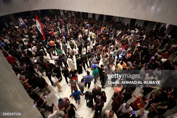 Supporters of the Iraqi cleric Moqtada Sadr gather inside the Iraqi parliament in the capital Baghdad's high-security Green Zone, as they protest at...