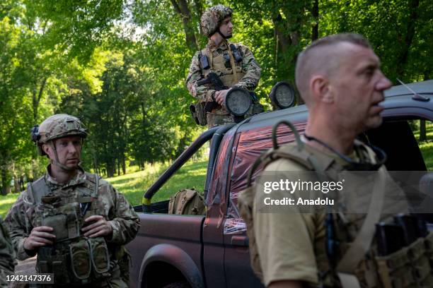 Ukrainian soldiers are seen outside of a humanitarian aid distribution center in Zolochiv, Ukraine on 27 July, 2022.