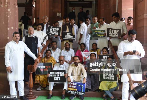 Suspended Congress MPs stage a protest over price hike of fuel and LPG cylinders, and increase in GST on essential commodities during the ongoing...