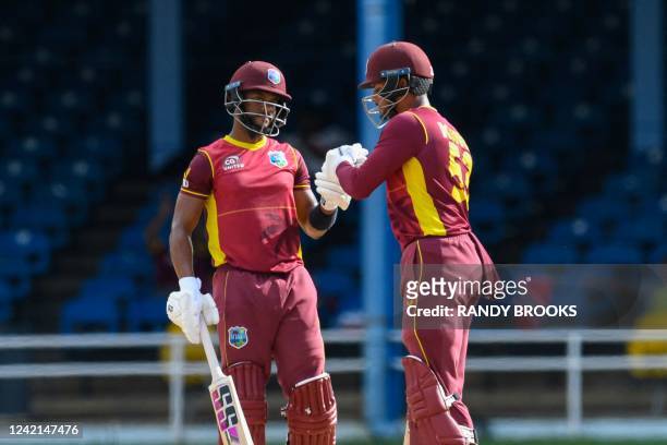 Shai Hope and Brandon King , of West Indies, knock gloves during the third and final ODI match between West Indies and India at Queens Park Oval in...