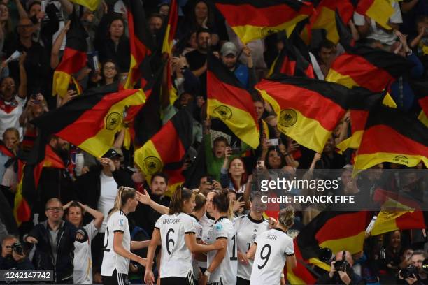 Germany's striker Alexandra Popp celebrates with teammates scoring her team's second goal during the UEFA Women's Euro 2022 semi-final football match...