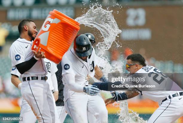 Victor Reyes of the Detroit Tigers gets doused with water by Harold Castro with Javier Baez celebrating after Reyes hit a walk-off double to defeat...