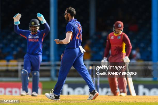 Axar Patel , of India, celebrates the dismissal of Brandon King , of West Indies, during the third and final ODI match between West Indies and India...