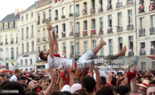 Crowds of revellers gather in front of the town hall, during the opening ceremony of The Fetes de Bayonne, in Bayonne, southwestern France on July...