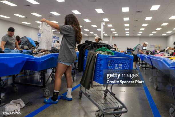 People sift through used clothes that are sold by the pound at a Goodwill Outlet Center on July 27, 2022 in Hackensack, New Jersey. Goodwill and...