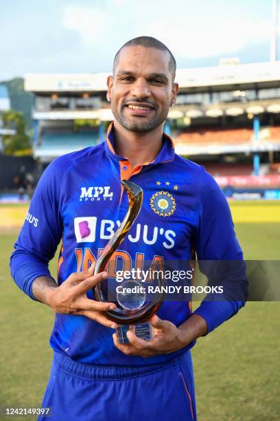 Shikhar Dhawan, of India, holds the winning trophy at the end of the third and final ODI match between West Indies and India at Queens Park Oval in...