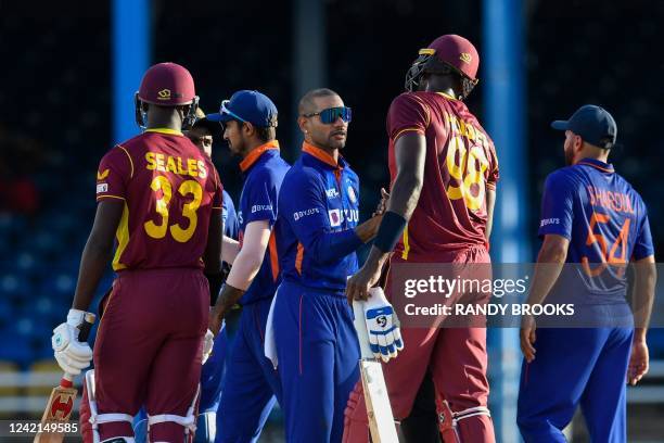 Shikhar Dhawan , of India, is congratulated by Jason Holder , of West Indies, during the third and final ODI match between West Indies and India at...