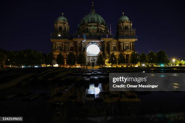 View of the darkened Berlin Cathedral with its facade illumination turned off on July 27, 2022 in Berlin, Germany. Berlin's Senate Department for the...