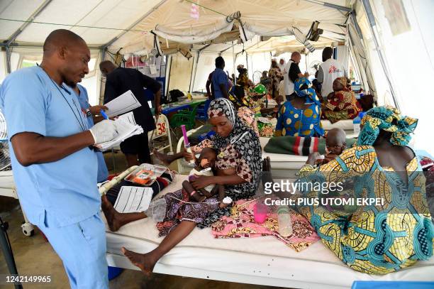 Nurse attends to mothers whose children are suffering malnutrition in a clinic set up by health authorities in collaboraion with Medecins Sans...