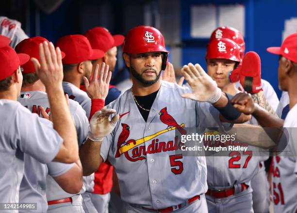 Albert Pujols of the St. Louis Cardinals celebrates in the dugout after hitting a 3 run home run in the fifth inning against the Toronto Blue Jays at...