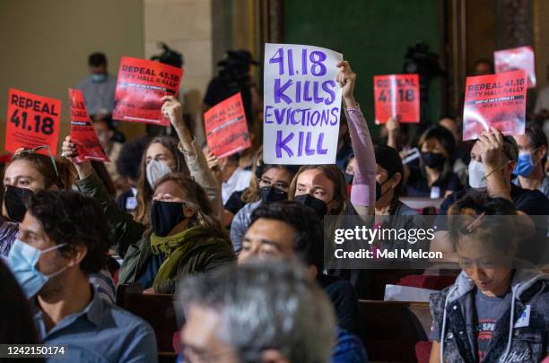 July 27, 2022:Joanna Swan, center, holds a sign showing that she is against a ban on homeless encampments near schools and daycare centers, while...