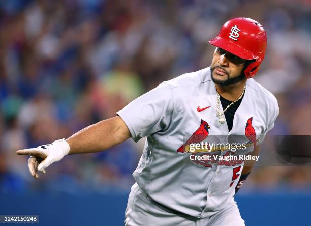 Albert Pujols of the St. Louis Cardinals points to the dugout after hitting a 3 run home run in the fifth inning against the Toronto Blue Jays at...