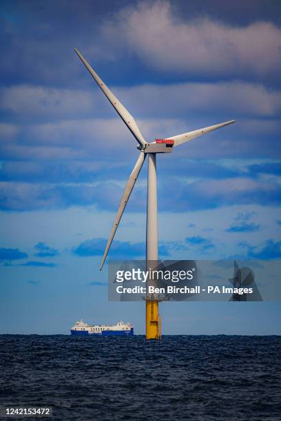 Ship passes wind turbines at RWE's Gwynt y Mor, the world's 2nd largest offshore wind farm located eight miles offshore in Liverpool Bay, off the...