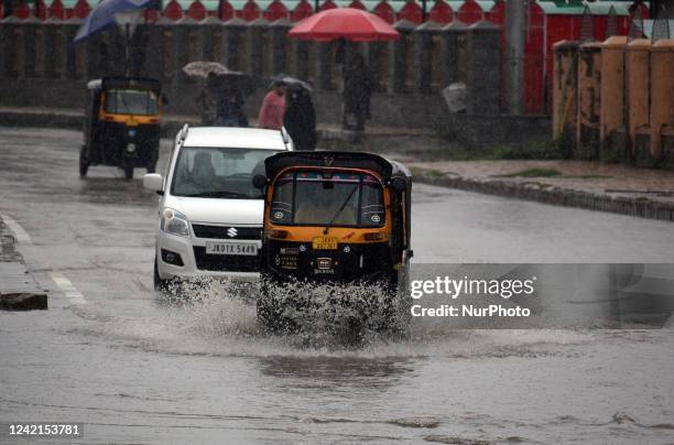 Vehicles moves through a waterlogged street as rains lash Srinagar, Kashmir on July 28, 2022. The weather department has predicted moderate to heavy...