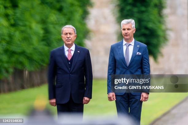 Turkish Defence Minister Hulusi Akar and Latvian Minister of Defence Artis Pabriks attend a ceremony to honor fallen soldiers at the Brother's...