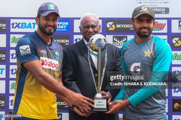 Sri Lanka's captain Dimuth Karunaratne and Pakistan's captain Babar Azam pose with the Test trophy after Sri Lanka won the second cricket Test match...