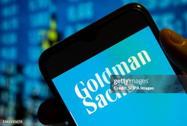 In this photo illustration, the American multinational investment bank and financial services company Goldman Sachs logo is displayed on a smartphone...