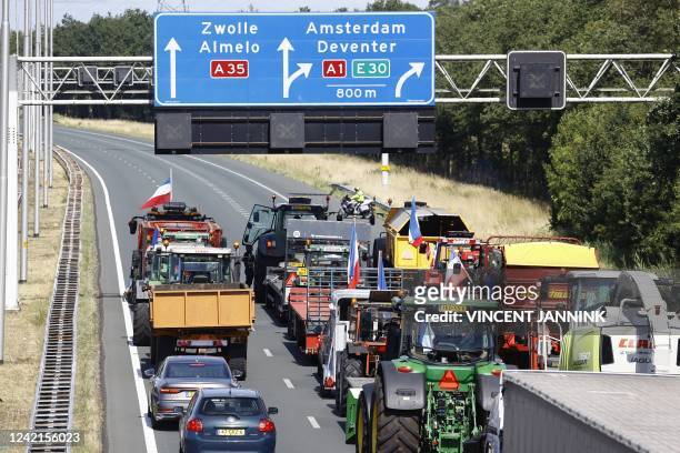 Farmers block the highway with their tractors they protest against the nitrogen plans causing delays due to the slow-moving of their vehicles near...