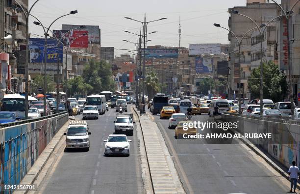 Cars drive along a street near central Baghdad's Tahrir Square on July 28 a day after supporters of Shiite cleric Moqtada al-Sadr stormed Iraq's...