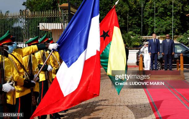 French President Emmanuel Macron is welcomed by Guinea-Bissau's President Umaro Sissoco Embalo upon his arrival at the presidential palace in Bissau,...