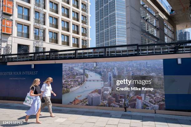 Construction site hoarding depicts an artists impression of the vast scale of the completed plan of the Nine Elms development in Battersea and...