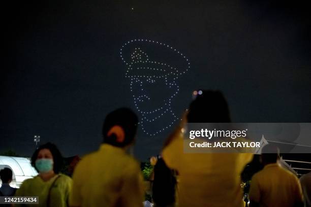 Illuminated drones fly to form a portrait of Thailand's King Maha Vajiralongkorn during celebrations to mark the King's 70th birthday outside the...