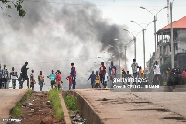 Protesters block roads and hurl rocks in Conakry on July 28 after authorities prevented supporters of the opposition party, National Front for the...