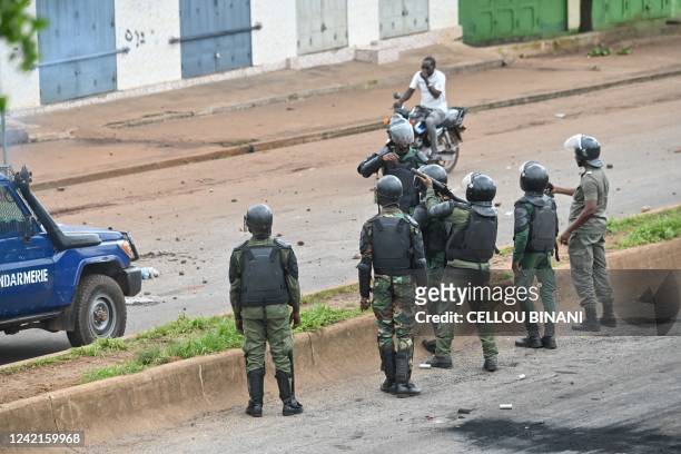 Guinea anti riot policemen fire teargas as protesters block roads and hurl rocks in Conakry on July 28 after authorities prevented supporters of the...