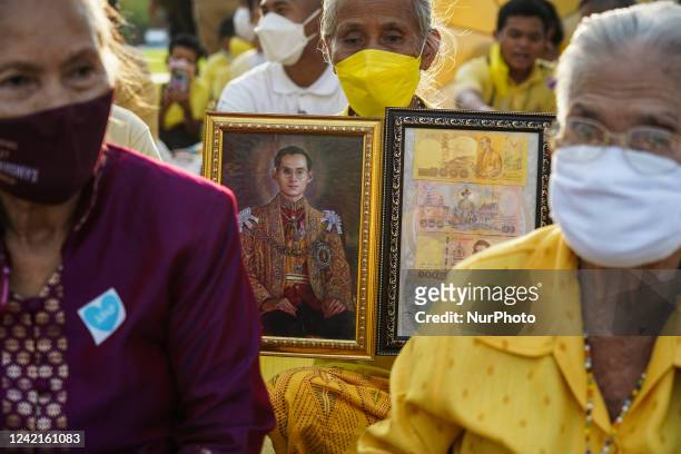 Thai Royalists hold photos of Thai King Bhumibol Adulyadej during a ceremony in the celebrations of the Thai King Maha Vajiralongkorn 70th birthday...