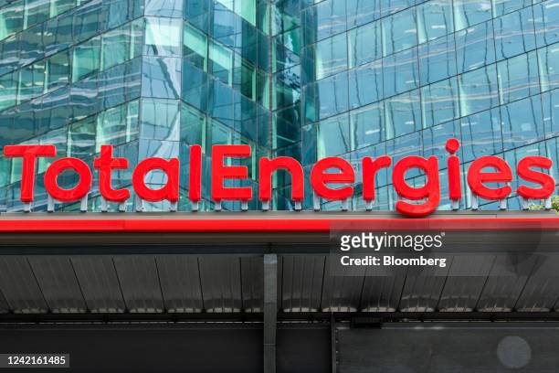 Signage for TotalEnergies SE at the company's electric vehicle charging station in the La Defense business district in Paris, France, on Thursday,...