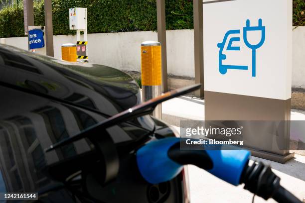 An electric vehicle recharges at a charging station operated by TotalEnergies SE in the La Defense business district in Paris, France, on Thursday,...