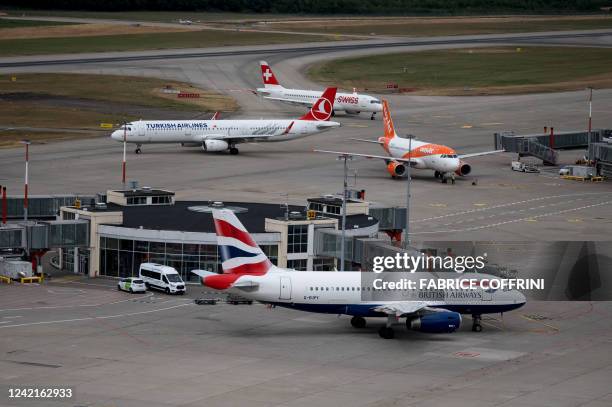 This photograph taken in Geneva on July 28, 2022 shows planes of carriers British Airways, Swiss International Air Lines, EasyJet and Turkish...