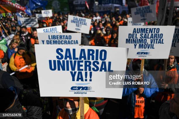 Members of social organizations march to Plaza de Mayo square demanding a universal basic salary and social aid amid the growing inflation in Buenos...