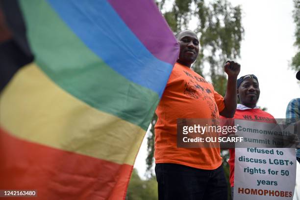 Demonstrators attend a protest calling for a ban on anti-LGBT+ laws in all Commonwealth Countries outside the Alexander Stadium in Birmingham,...