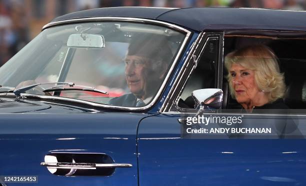 Britain's Prince Charles, Prince of Wales drives with Britain's Camilla, Duchess of Cornwall in an Aston Martin sports car into the opening ceremony...