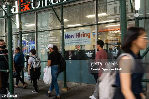 Now hiring" sign is displayed in a window in Manhattan on July 28, 2022 in New York City. The Commerce Department said on Thursday that the nation's...