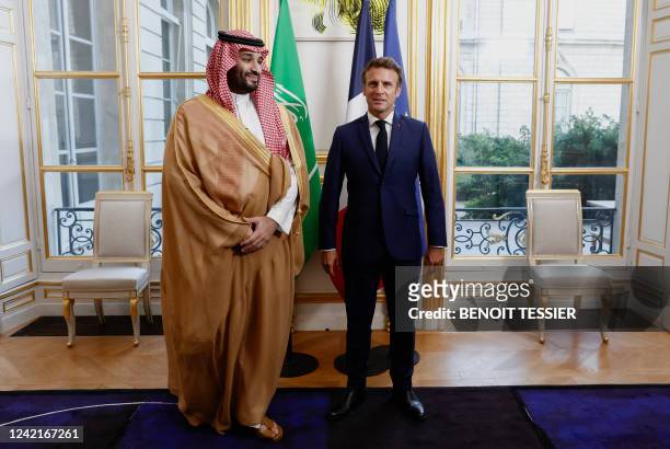 France's President Emmanuel Macron poses with Saudi Crown Prince Mohammed bin Salman upon his arrival at presidential Elysee Palace in Paris on July...