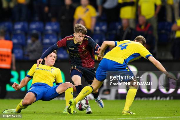 Pogon Szczecin's Kacper Smolinski is challenged by Broendby's Joe Bell during the Europa Conference League qualifying football match between Broendby...