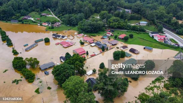 Aerial view of homes submerged under flood waters from the North Fork of the Kentucky River in Jackson, Kentucky, on July 28, 2022. At least three...