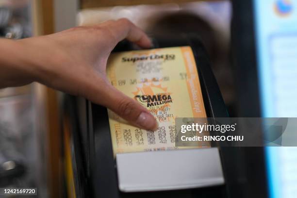 Cashier prints out a Mega Millions lottery ticket at a 7-Eleven convenience store in Chino Hills, California, July 28, 2022. The odds of claiming...